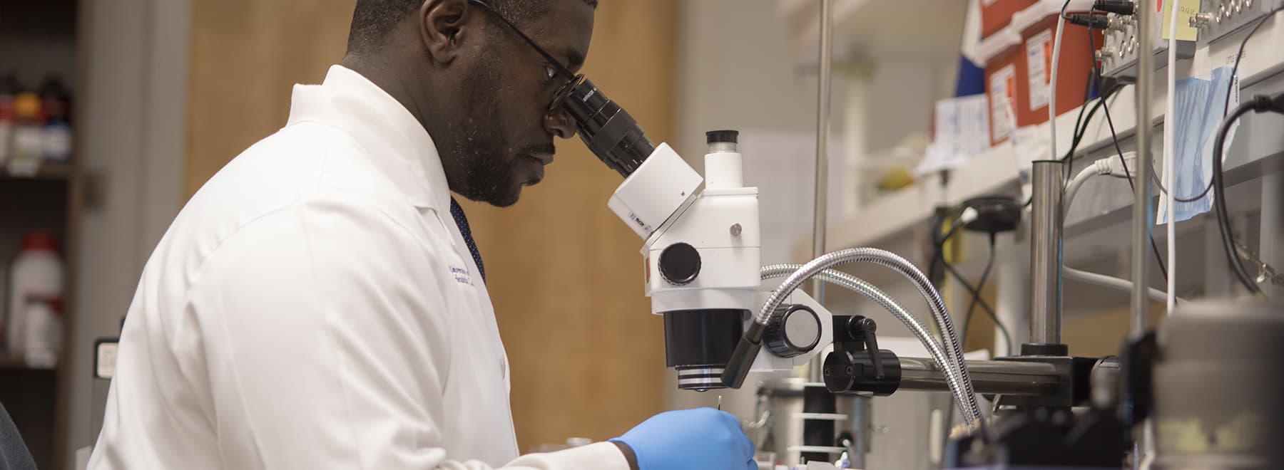 A scientist reviews test tubes.